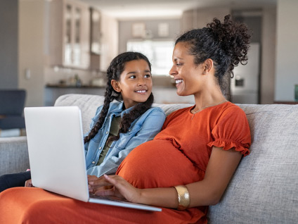 mother and daughter using a computer together